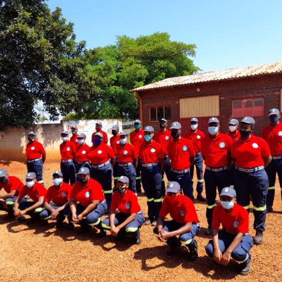 Group of learners in academy uniform outside a training facility