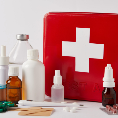 First aid kit with medical supplies on a white surface